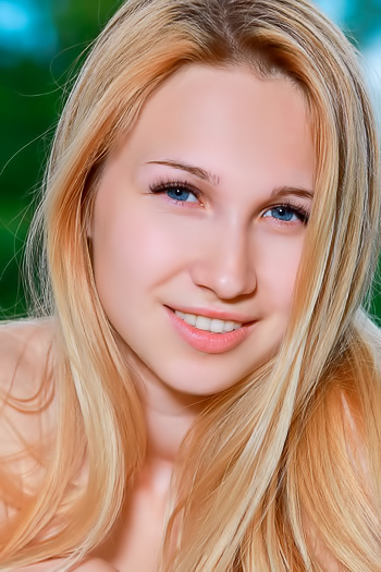 Petite redhead spreads her shaved pussy open