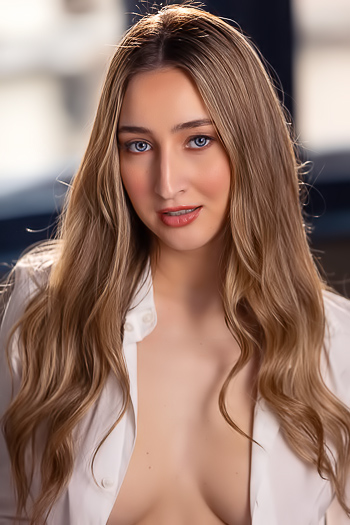 Lula Stocch relaxes in bed wearing sheer panties and button up shirt